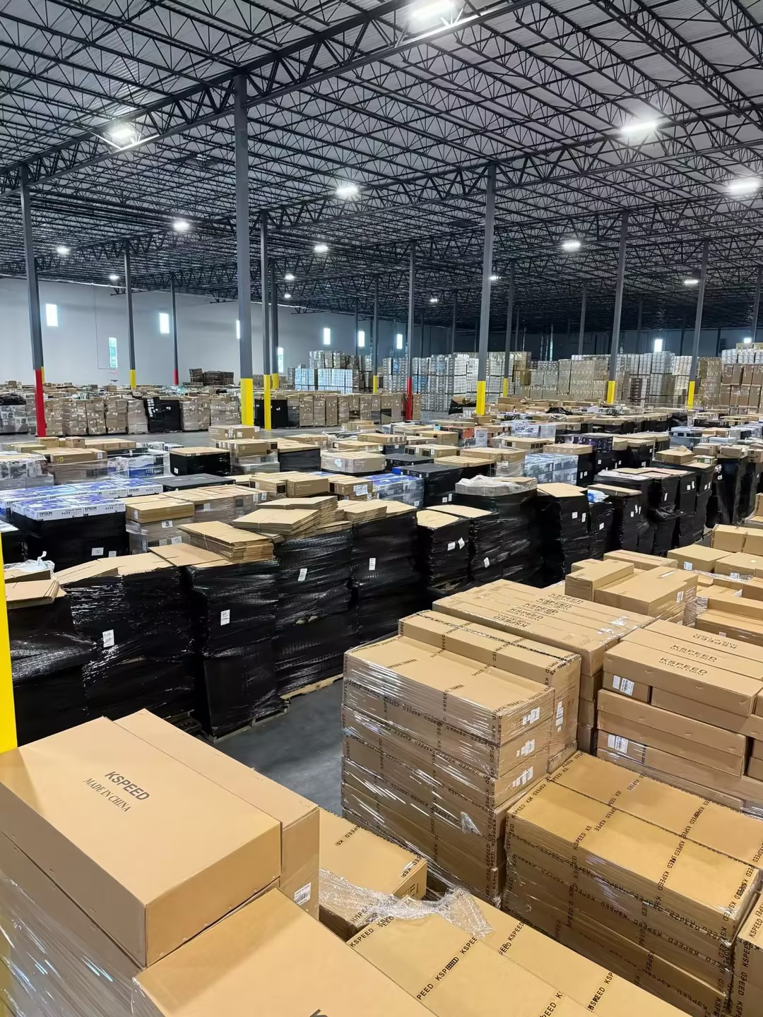 Modern order fulfillment warehouse with pallets of packed parcels staged for outbound shipping, showing completed pick and pack execution